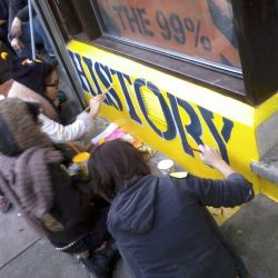 Volunteers painting front of museum